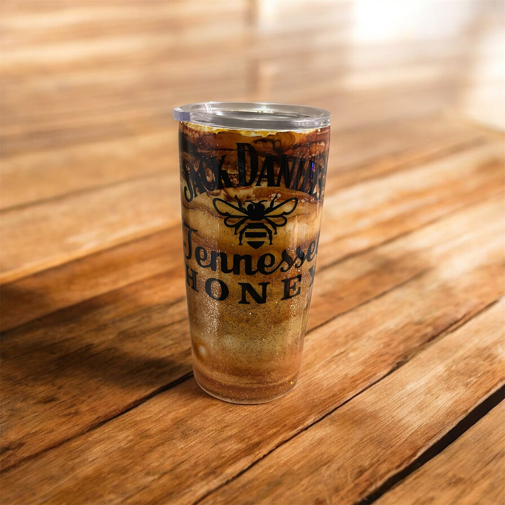 Tumbler with Jack Daniel's Tennessee Honey logo on a wooden surface